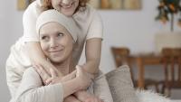 Female patient hugged by another woman